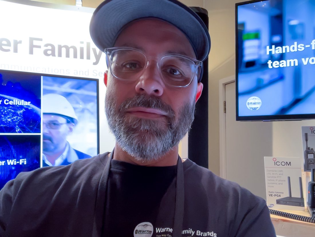 Mark at a trade show booth he built and worked